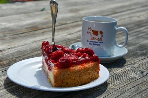 Fine cake and cocoa on the terrace of the hut
